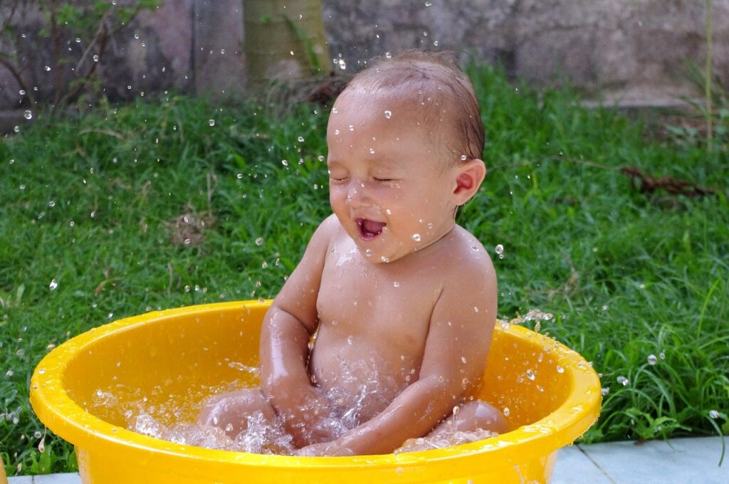 Bebê toma banho em uma pequena banheira: entre as preocupações mais comuns dos pais está a hora do banho do recém-nascido
